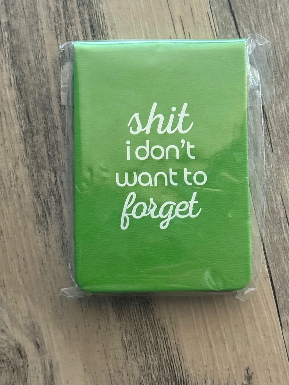 Green Notebook with White 'shit i don't want to forget' Text